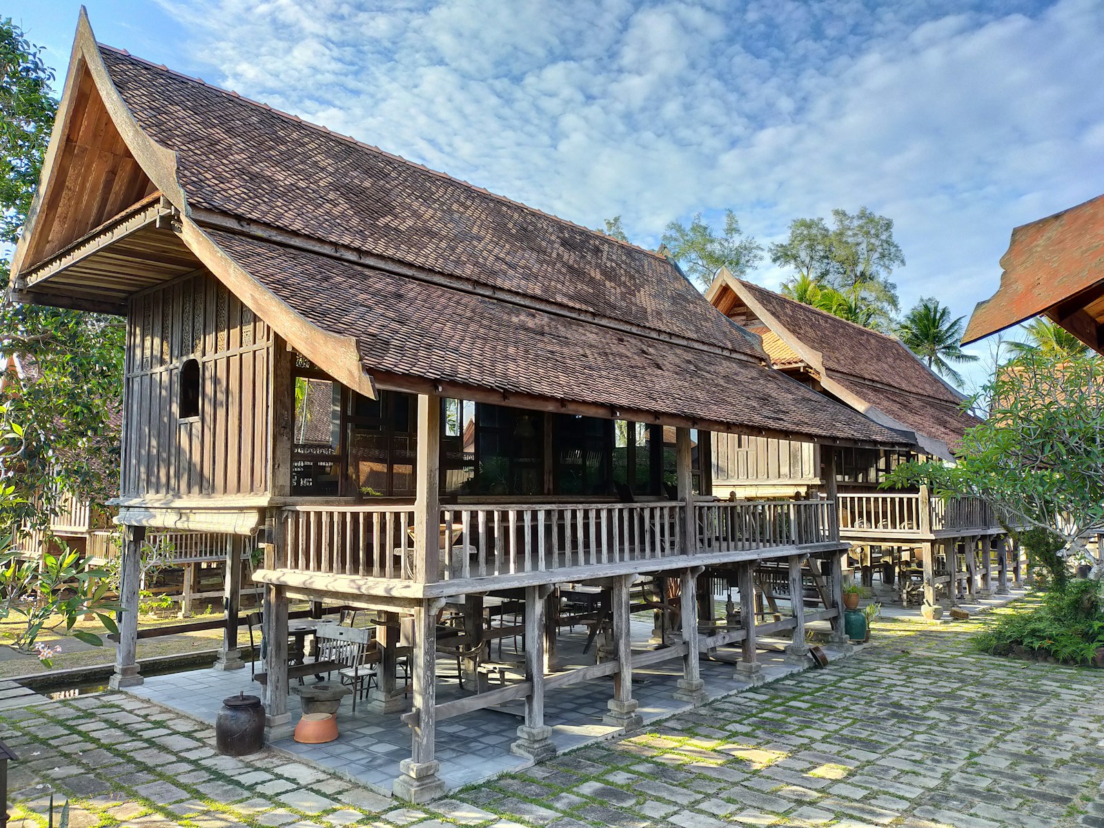 Traditional wooden house beside water.